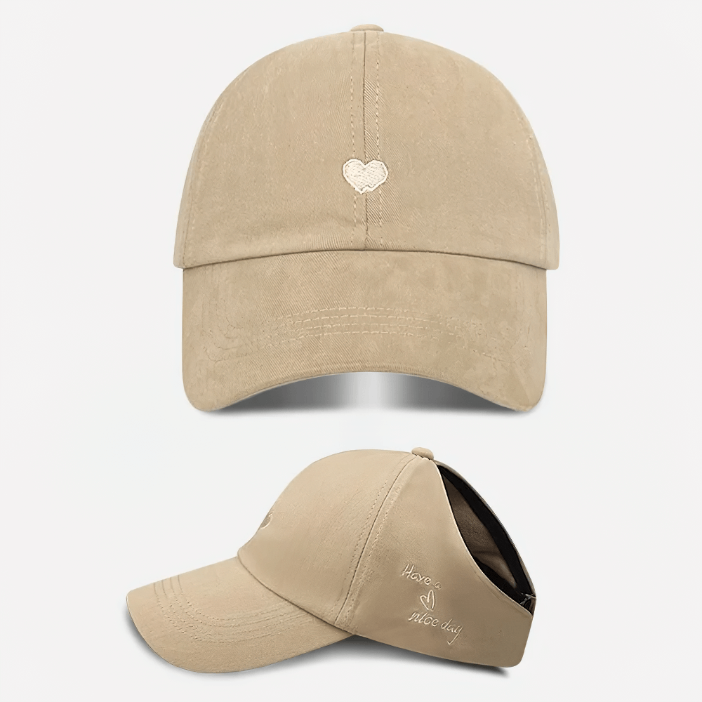 Khaki cotton baseball cap with adjustable strap and heart design, perfect for casual outings. Trendy and versatile headwear accessory.